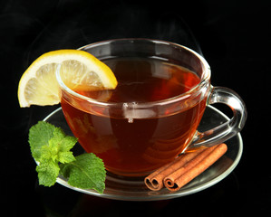 Cup of tea with lemon isolated on black