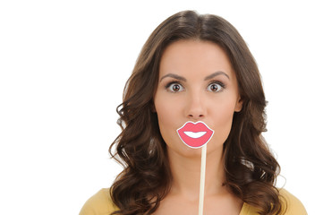 Making a face. Surprised young women holding fake lips on stick