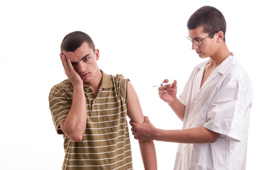 Young doctor give an injection to a pacient who is very afraid o