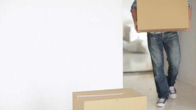 man moving big cardboard boxes