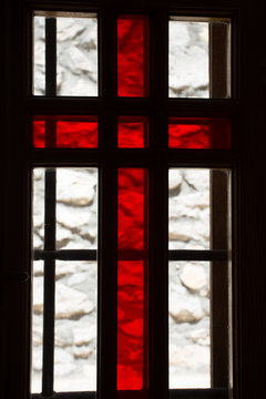 Stained window with red cross in a church