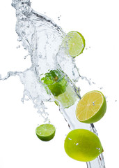 Fresh lime falling in water splash, isolated on white backgro