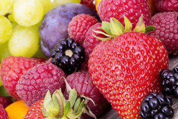 tasty summer fruits on a wooden table