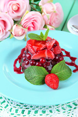 Tasty jelly dessert with fresh berries, on bright background