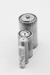 Old batteries on white background