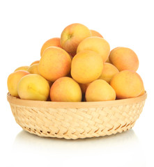 Fresh natural apricot in wicker basket isolated on white
