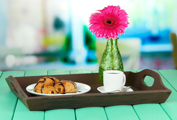 Wooden tray with breakfast, on bright background