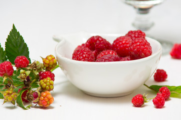 Fresh wild raspberries in a small plate