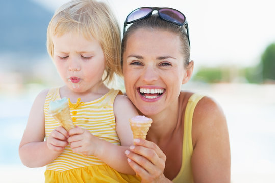 Happy mother and baby eating ice cream
