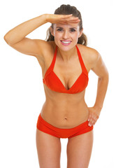 Fototapeta premium Happy young woman in swimsuit looking into distance