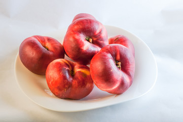 Fototapeta na wymiar flat peach on white plate