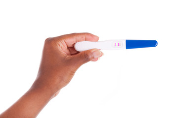 Black woman hand holding a positive pregnancy test - African peo
