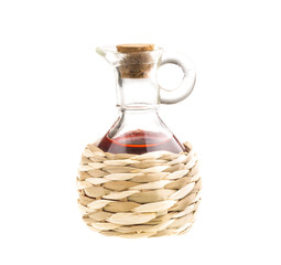 Small decanter with red wine vinegar isolated on the white
