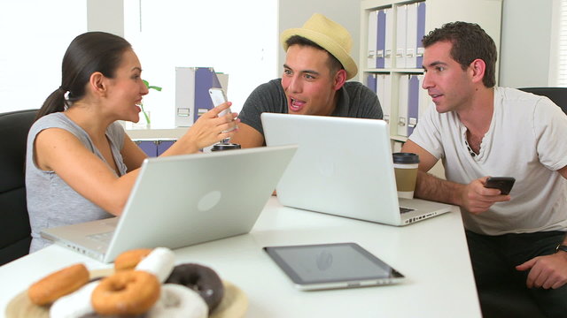 Mexican and Caucasian coworkers working together at desk