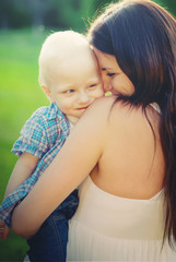 Young Mother and her little son, filled with tenderness, toned