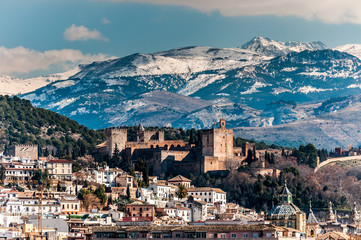 Winter view of famous Alhambra in front of Sierra Nevada. - obrazy, fototapety, plakaty