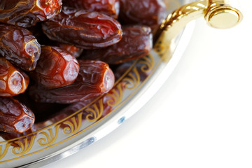 Dried Arabic dates presented on an ornate tra