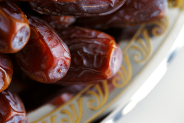 Dried Arabic dates presented on an ornate tra