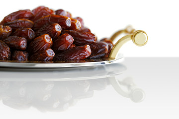 Dried Arabic dates presented on an ornate tra
