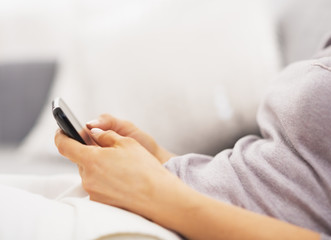 Closeup on young woman writing sms