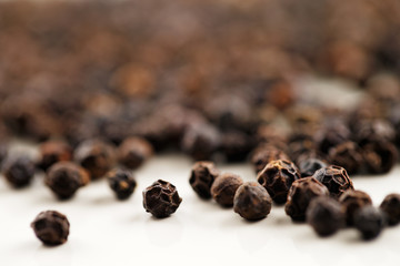 A macro image of black peppercorns