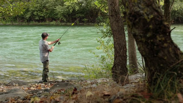 6of8 Man with rod fishing trout on river in Italy
