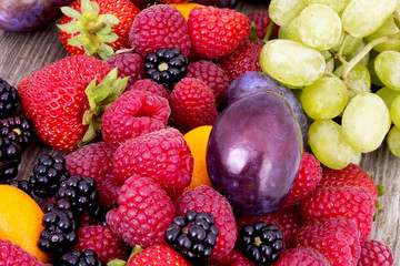 tasty summer fruits on a wooden table