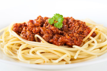 Spaghetti bolognese decorated with coriander leaf