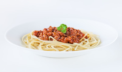 Spaghetti bolognese decorated with coriander leaf