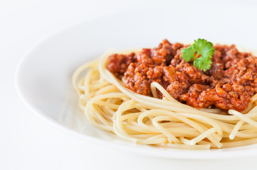 Spaghetti bolognese decorated with coriander leaf