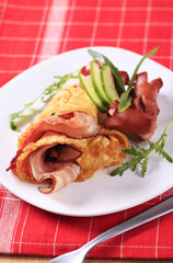 Fototapeta na wymiar Egg omelet with bacon and sausages