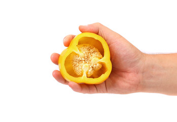 Hand holds half of yellow pepper.