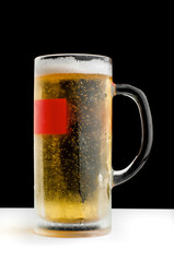 Refreshing mug of cold beer on black background