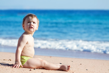  toddler  on sand beach