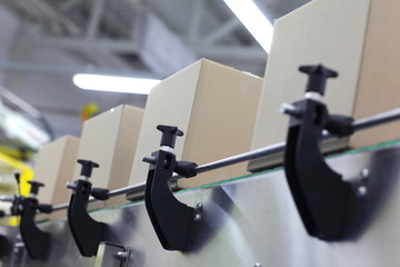 Cardboard boxes on conveyor belt in factory