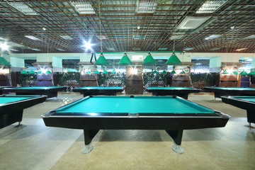 Billiard tables with green cloth inside club