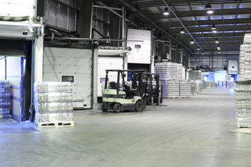 Packaged beer and loader machine in warehouse