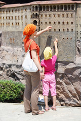 Mother and daughter touch walls of Sumela Monastry