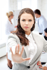 angry businesswoman showing stop gesture