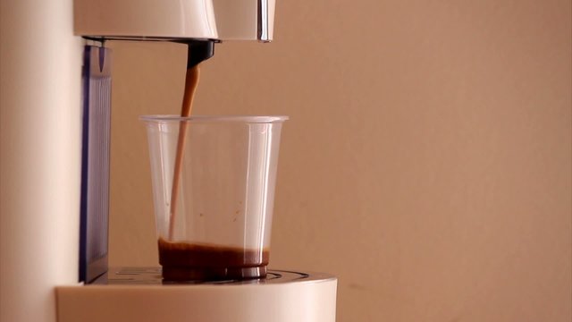Home expresso machine taking coffee
