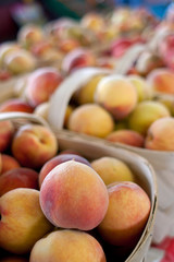 Baskets Of Ripe Peaches For Sale At Farmers Market