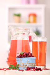 Pitcher and glass of cranberry juice with red cranberries