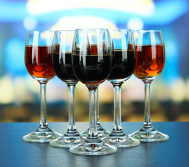 Glasses of liquors, on bright background