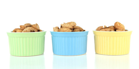 Almond in bowls, isolated on white