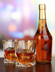 Glass of whiskey with bottle, on dark background