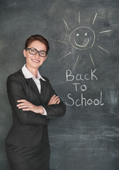 Happy teacher and smiling sun on the chalkboard