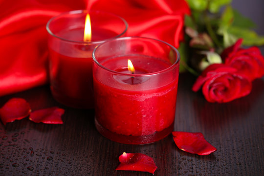 Beautiful romantic red candle with flowers, close up
