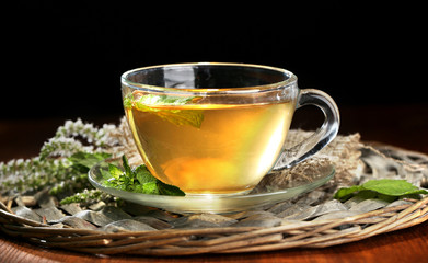 Cup of herbal tea with fresh mint flowers