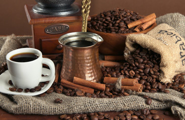 Metal turk and coffee cup on dark background
