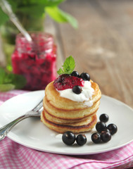 Pancakes with sour cream and black currant jam